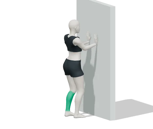 Calf stretch, step 1: Face a wall, hands on it